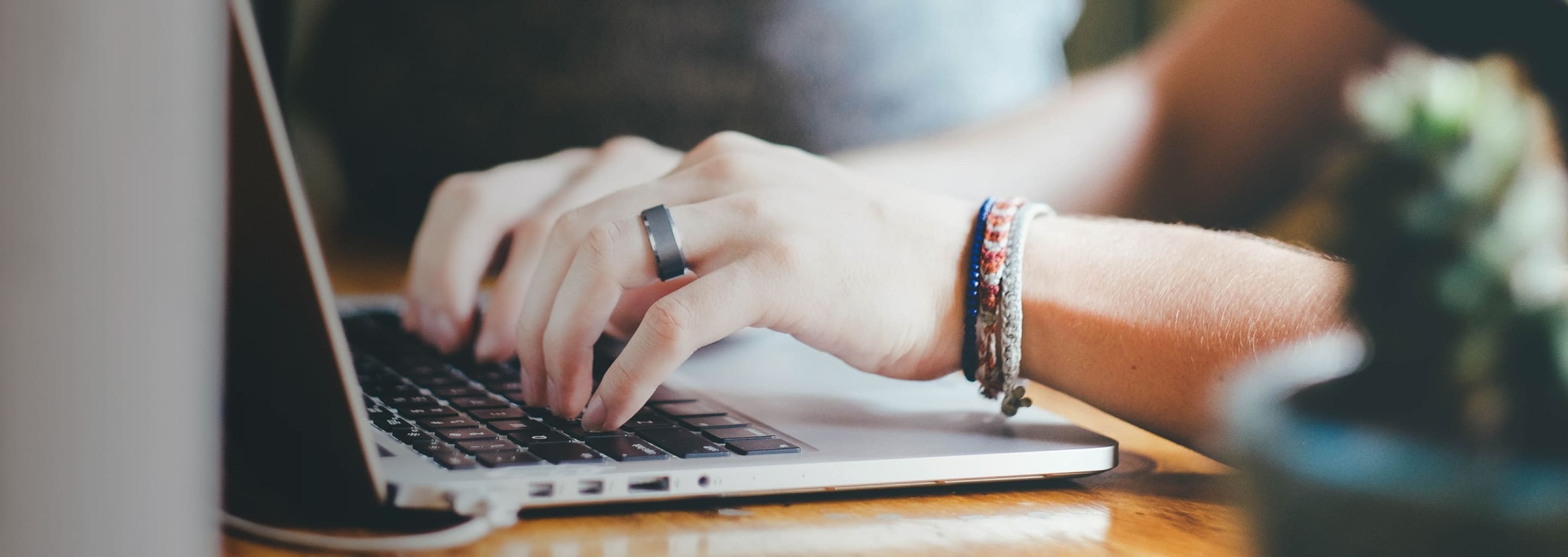 fingers typing on MacBook