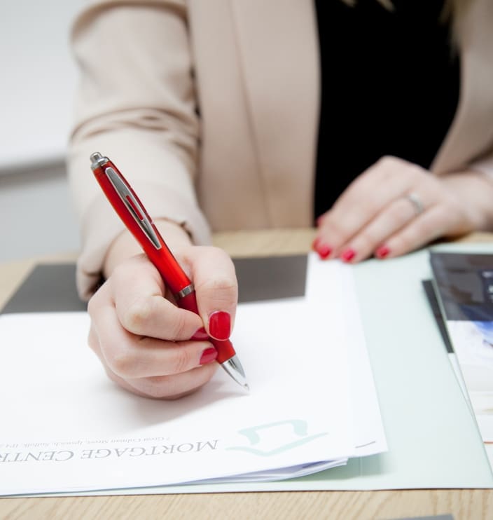 women writing with red pen