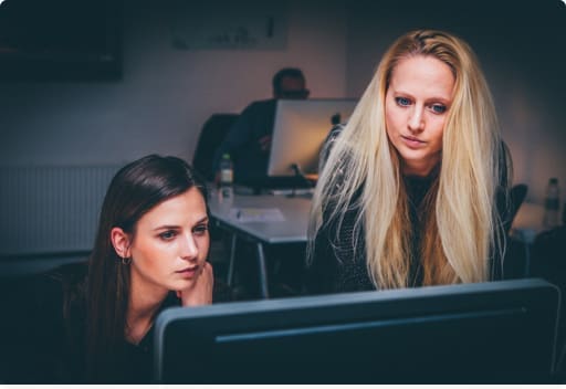 two women looking at computer screen