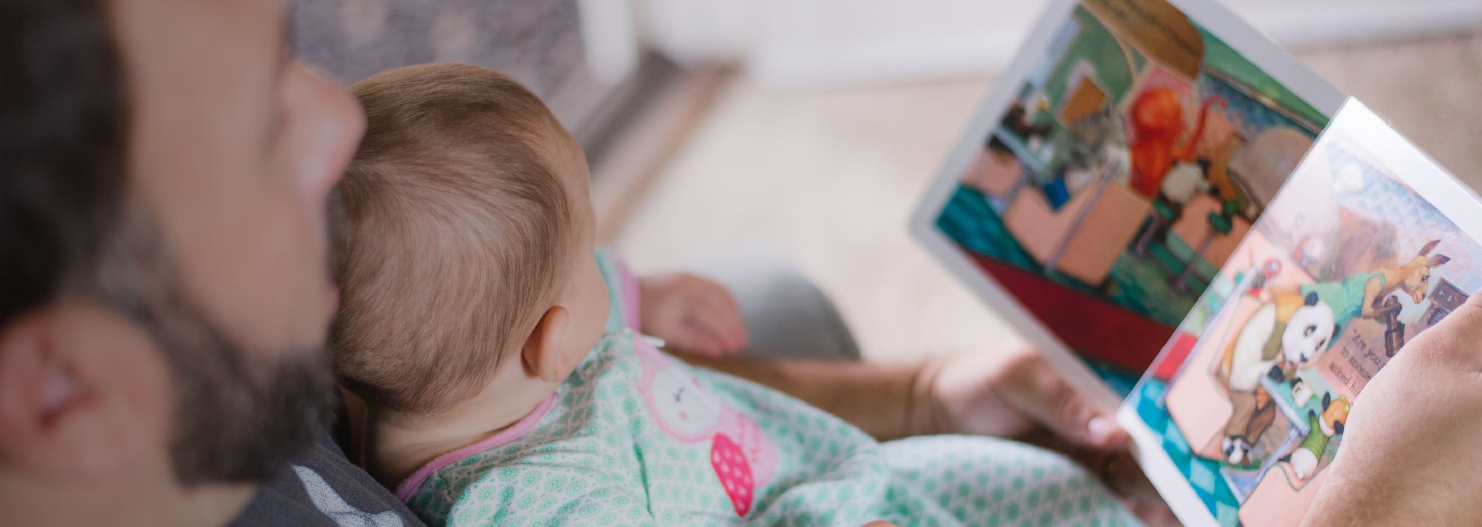 Father reading book with young child