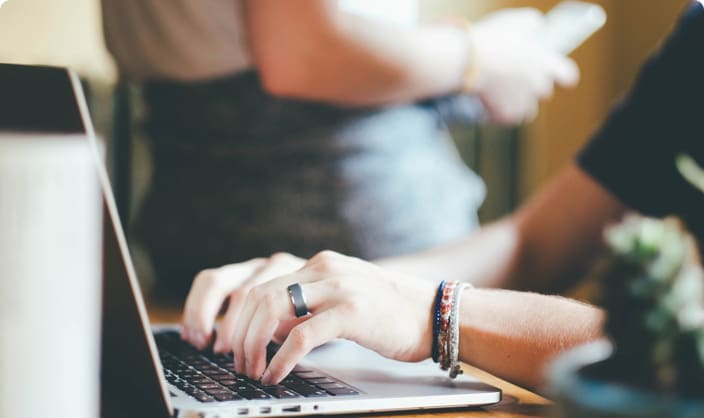 close up image of hands typing on a laptop