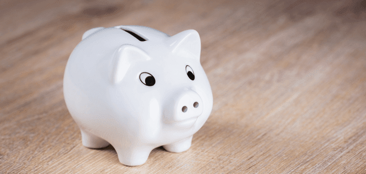 white piggy bank on wooden floor