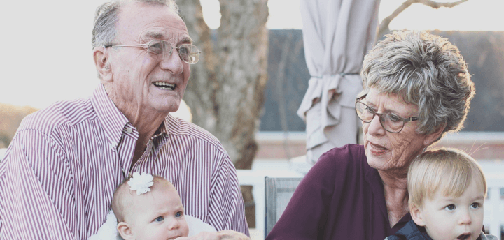 elderly couple with young children