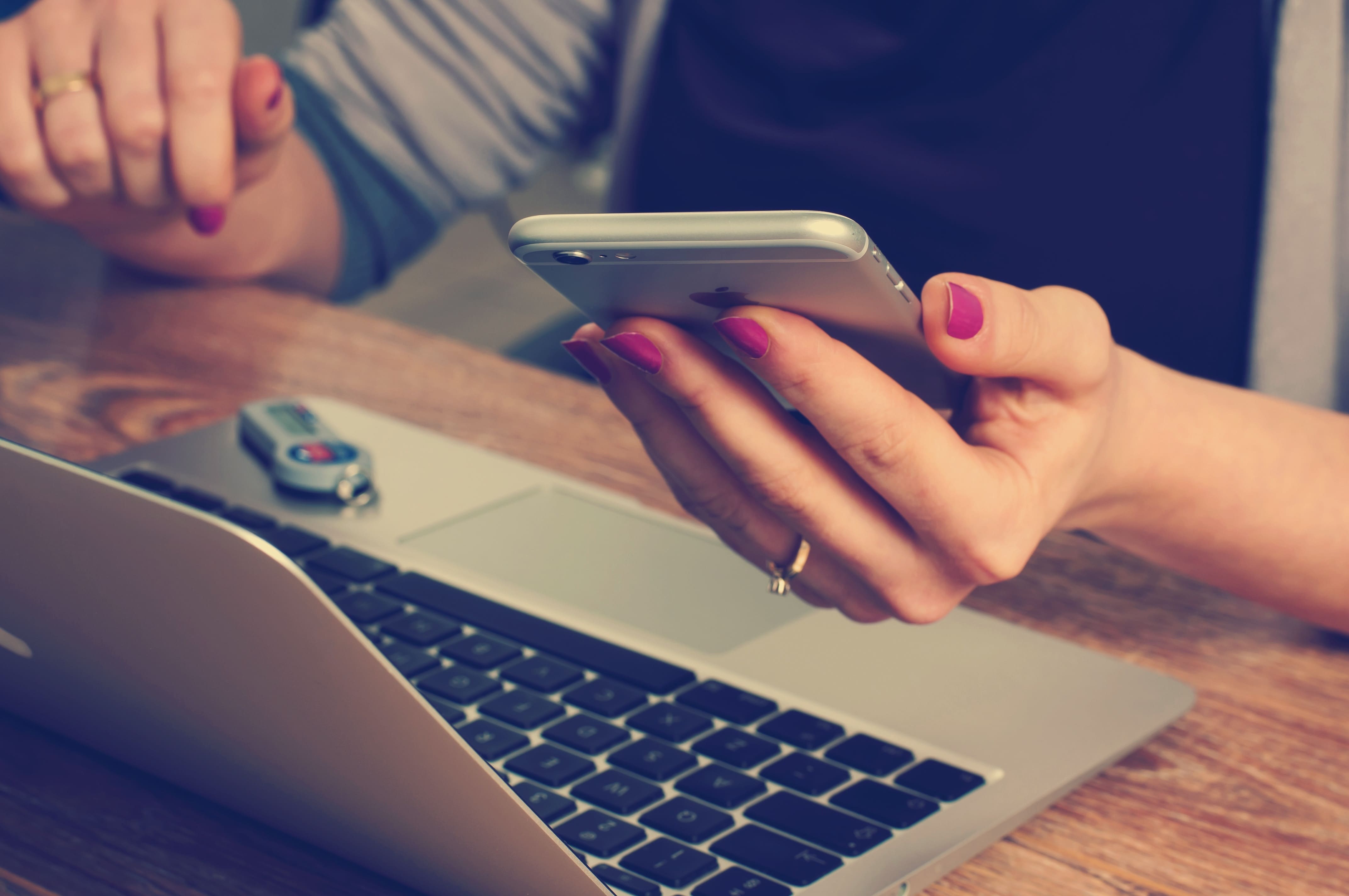 a person on a phone and laptop