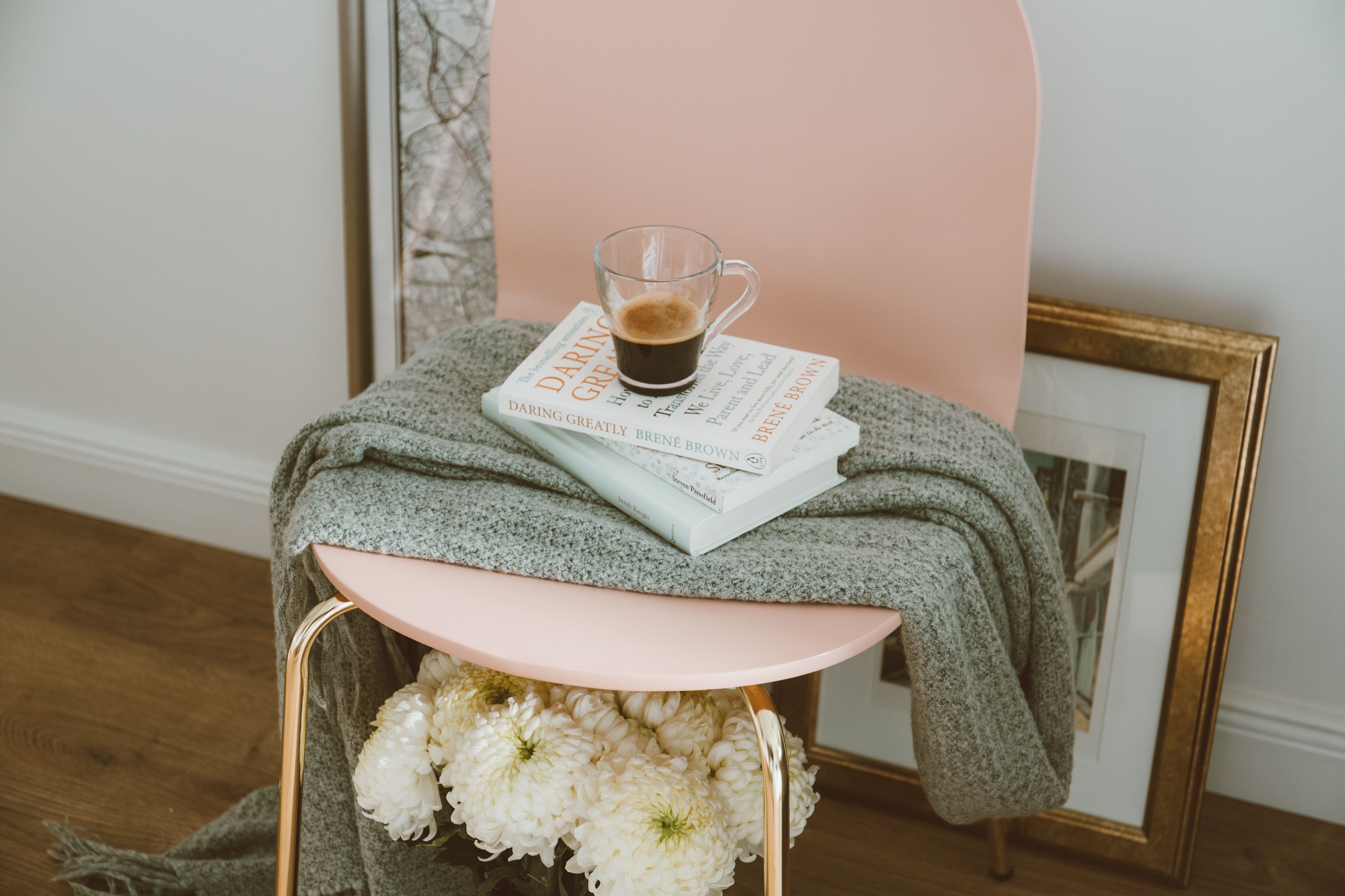 a pink chair with books on it