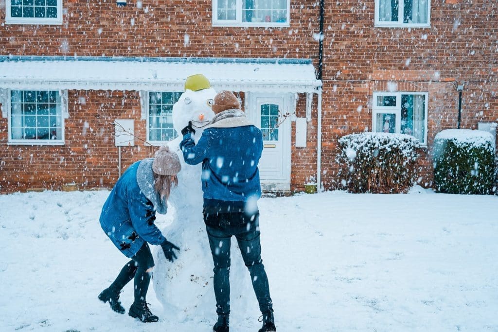 people building a snowman