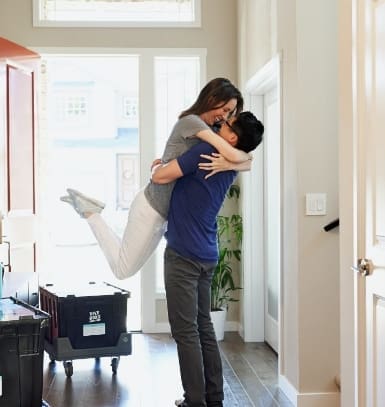 a couple hugging in a doorway