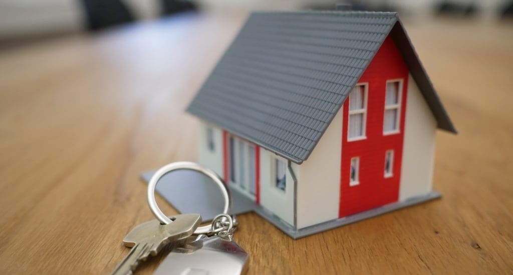 a model house next to some keys