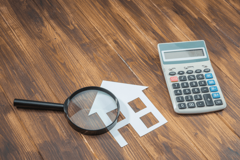 a calculator and magnifying glass on a desk