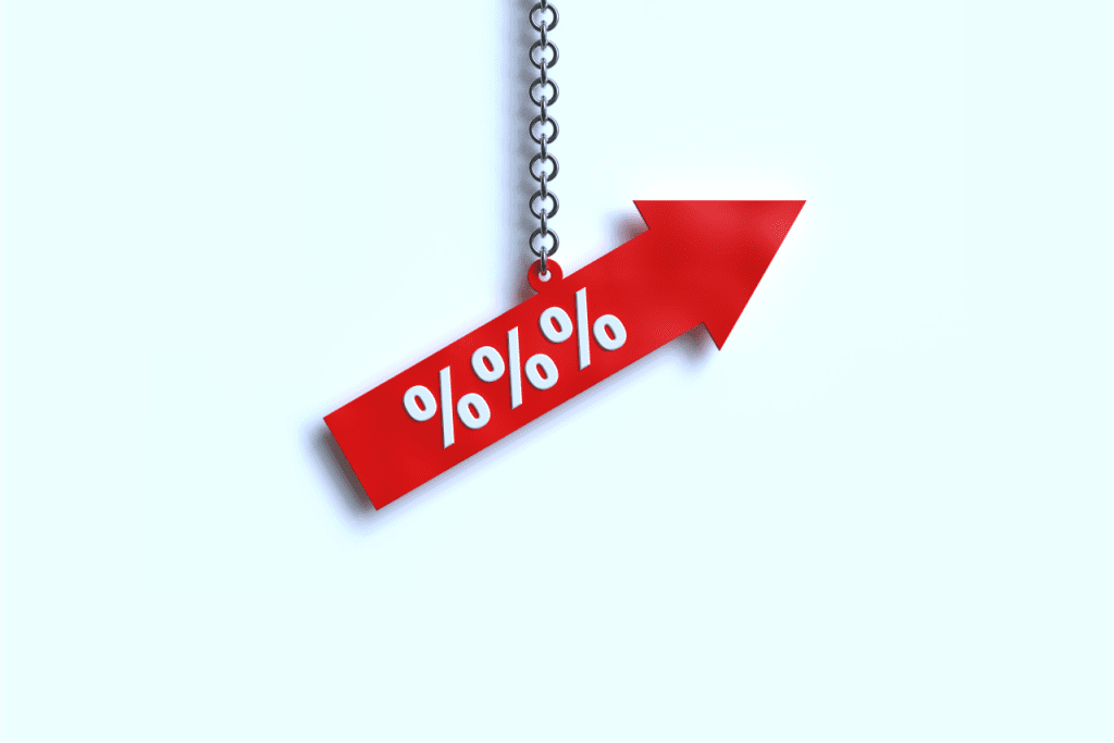 a red arrow hanging from a chain with percentage signs on