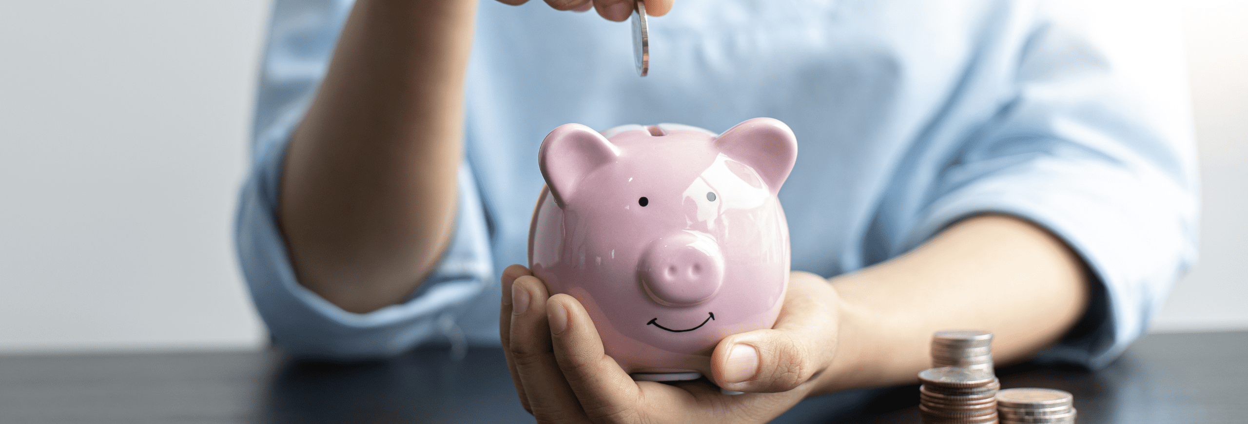 a person putting money in a money bank