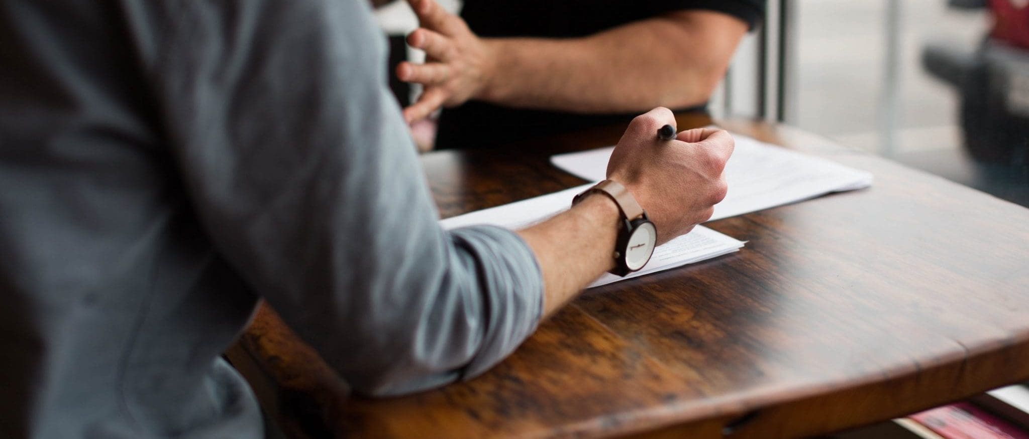 people talking about a document at a table