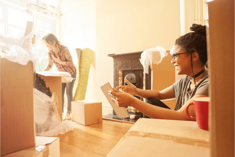 two women unpacking in a new house